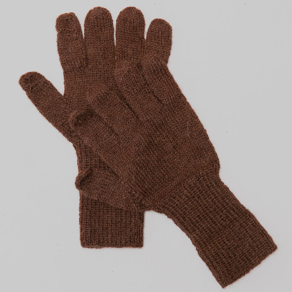 A pair of brown knit gloves with ribbed cuffs,