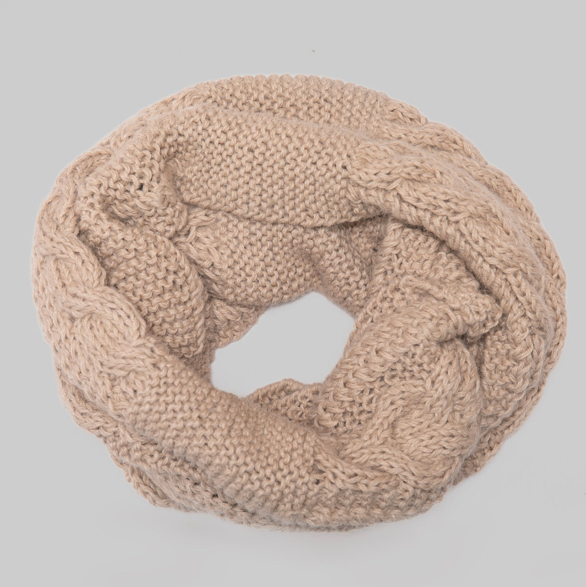 A beige cable-knit infinity scarf, shown in a loop shape.