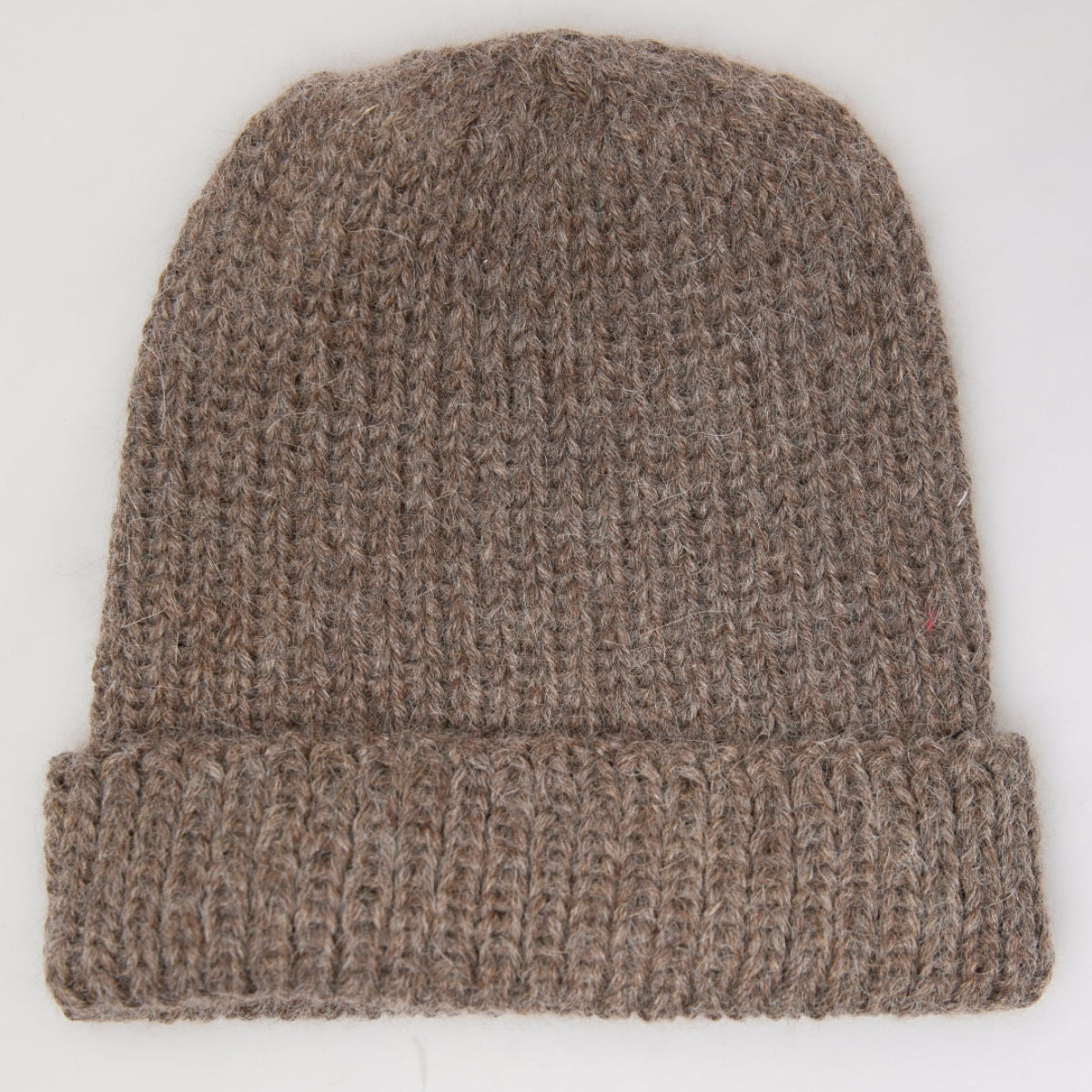 A brown ribbed knit beanie hat with a folded cuff.
