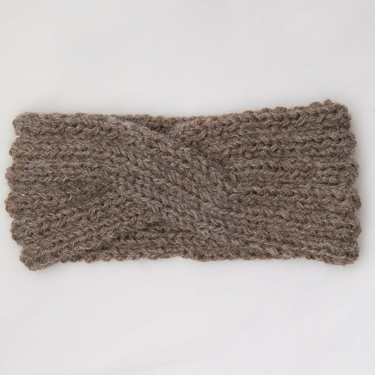 A chunky knit cable twist headband in a taupe brown color,
