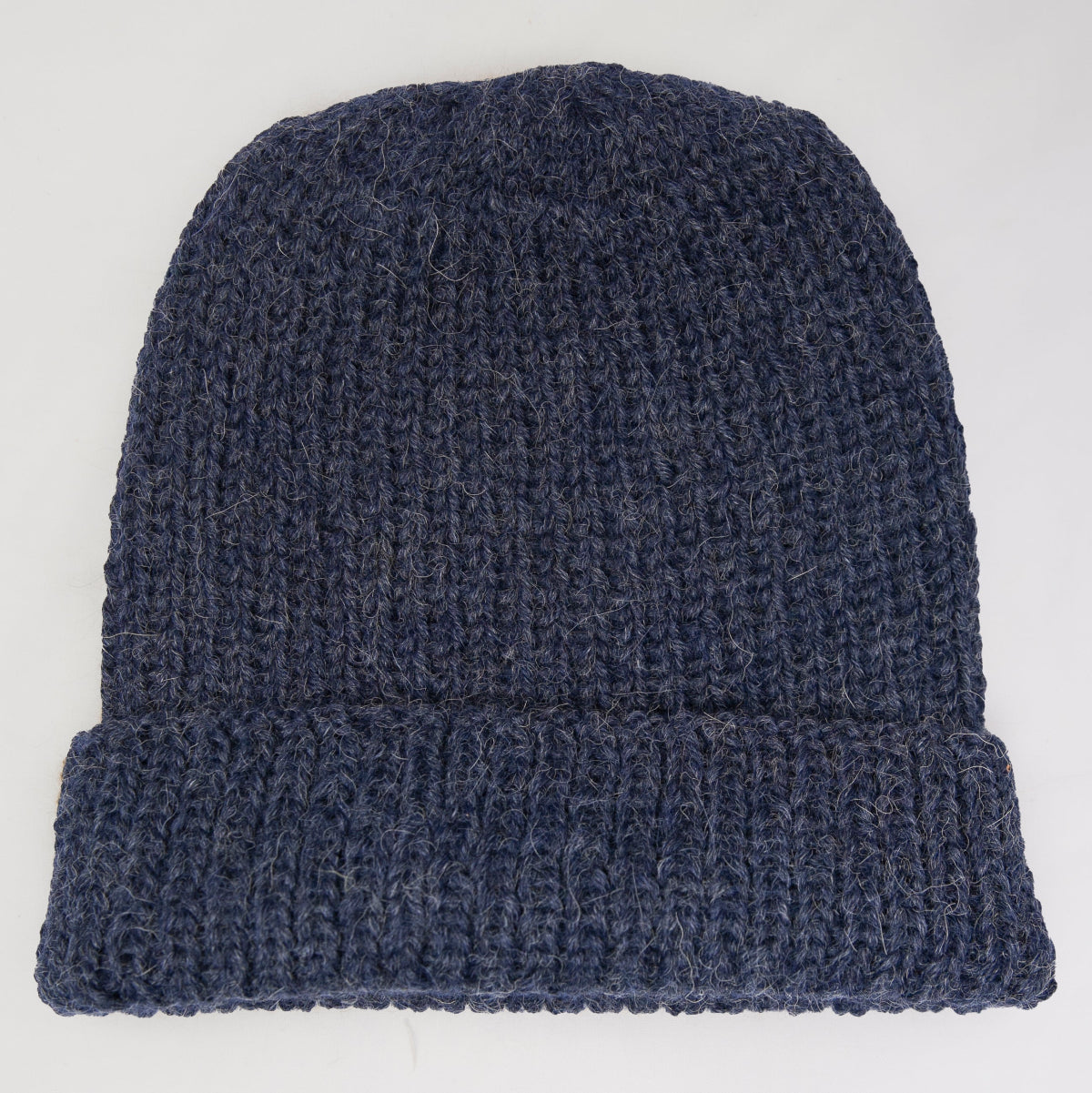 A dark navy blue knit beanie hat with a folded cuff.