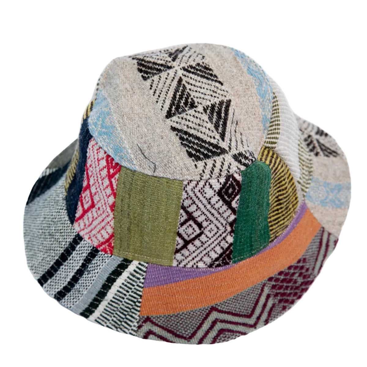 A patchwork fedora hat made from various colorful woven fabric panels with geometric patterns.