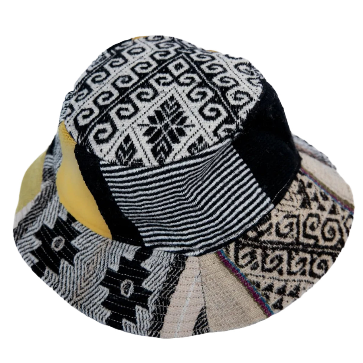 A patchwork fabric bucket hat featuring various geometric and striped textile patterns in black, beige, and yellow.